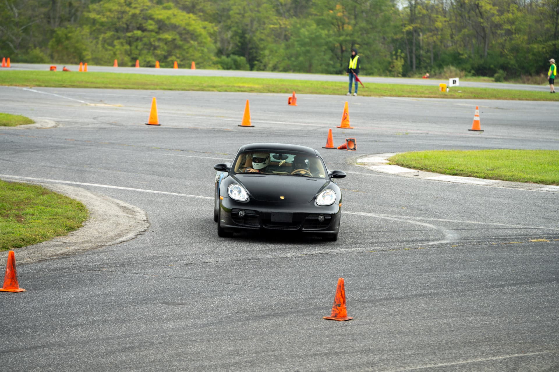 Black Porsche Cayman navigating an autocross course